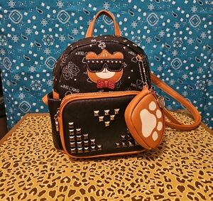 Stylish Black and Orange Backpack with Textured Surface and Rounded Shape